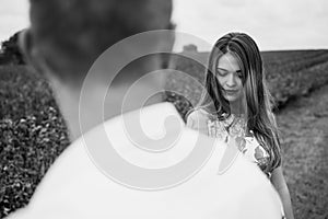 A girl and a guy are walking in the nature. Portrait of a couple, a love story.Happy smiling, loveing couple together outstretched