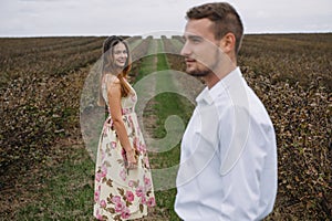 A girl and a guy are walking in the nature. Portrait of a couple, a love story.Happy smiling, loveing couple together outstretched