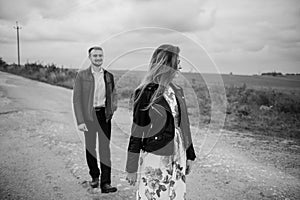 A girl and a guy are walking in the nature. Portrait of a couple, a love story.Happy smiling, loveing couple together outstretched