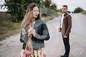 A girl and a guy are walking in the nature. Portrait of a couple, a love story.Happy smiling, loveing couple together outstretched