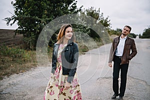 A girl and a guy are walking in the nature. Portrait of a couple, a love story.Happy smiling, loveing couple together outstretched