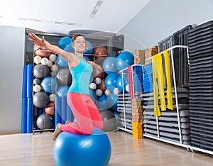 Girl at gym swiss ball knee balance drill exercise