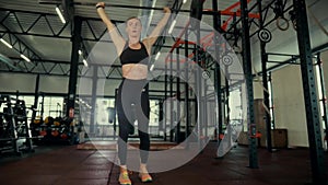 A girl in the gym trains. Sexy young woman is engaged in simulators in the gym. Beautiful sport figure.
