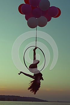 Girl gymnast doing tricks on ring.