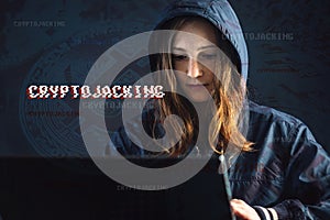 Girl hacker with a face is trying to steal cryptocurrency using a computer. Fraud and scam at Cryptojacking