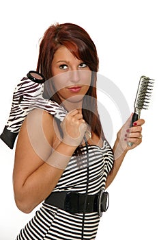 Girl with hair dryer and brush