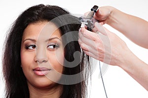 Girl hairdo with electric hair curler