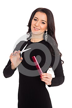 Girl hairdresser holding scissors and comb