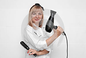 Girl hairdresser with scissors and a comb in her hands