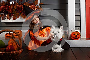 Girl in halloween costume with dog