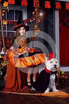 Girl in halloween costume with dog