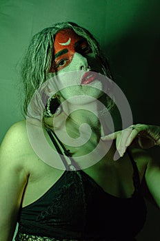 Girl with Halloween makeup. Halloween outfit. Dark atmosphere Halloween photo. Halloween.Girl smokes a vape