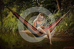 Girl in a hammock with a phone in his hand