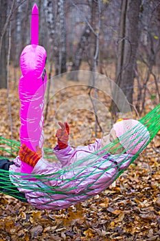 A girl in a hammock with a pink phone