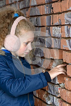 Girl hand in the gap of the wall. Teenager reaches out to wall hole.