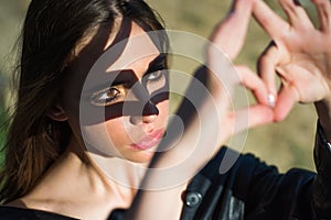 Girl with hand gesture. Woman with fashion makeup. Spring woman. Springtime and vacation. Face and skincare. Girl in sun