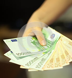 Girl hand Giving money euros photo