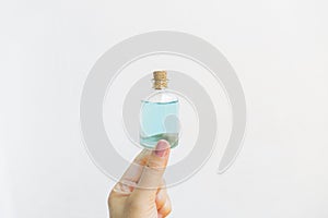 Girl hand holding alcohol bottle on white background, hand sanitizer