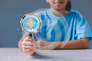 Girl hand holding magnifying glass with virtual Artificial Intelligence and virtual digital brain. AI Technology.