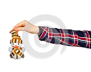 Girl hand holding snowman toy