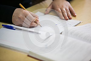 Girl hand writing down new information in exercise book