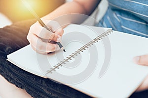 Girl hand writing note blank book