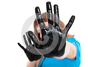 Girl with hands in black paint