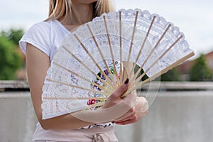 Summer Chic: Cooling Off with an Elegant Lace Hand Fan photo