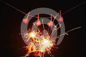 Girl hands holding bengal light blurred sparklers