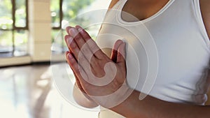 Girl with hands in praying position before meditation