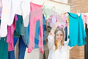 Girl hanging clothes to dry
