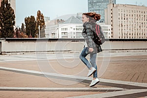 Girl happily skipping through the city center