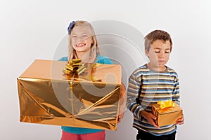 Girl happy with a big present box but her brother has only a small one