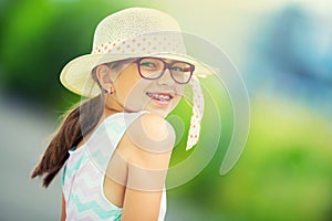 Girl.Happy girl teen pre teen. Girl with glasses. Girl with teeth braces. Young cute caucasian blond girl in summer outfit