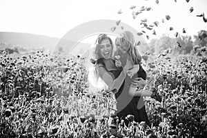 Girl and little boy or child in field of poppy