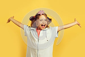 Girl with happy smiling face isolated on warm yellow background