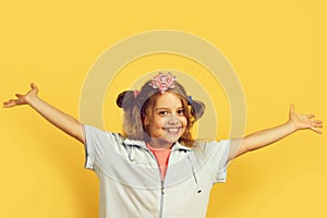 Girl with happy smiling face isolated on warm yellow background