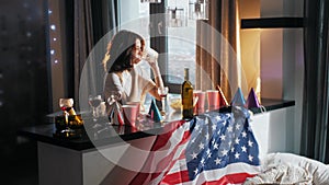 Girl has a hangover and is sitting among the mess and garbage left behind after the party.