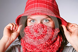 Girl has muffled in a scarf.