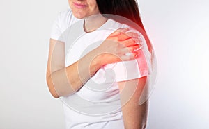 A girl has pain in her shoulder due to a pinched nerve in the cervical spine, osteochondrosis of the spine. Referred