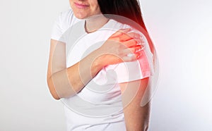 A girl has pain in her shoulder due to a pinched nerve in the cervical spine, osteochondrosis of the spine. Referred photo