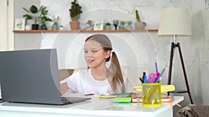 Girl has remote online school lessons at home.