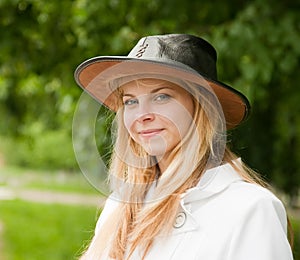 Girl in hat against park