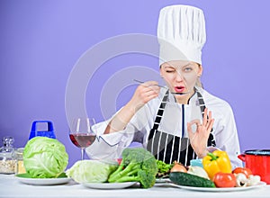 Girl in hat and apron. Cooking healthy food. Fresh vegetables ingredients for cooking meal. Professional cooking tips