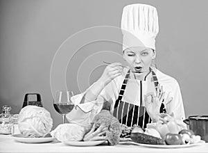 Girl in hat and apron. Cooking healthy food. Fresh vegetables ingredients for cooking meal. Professional cooking tips