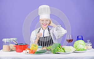 Girl in hat and apron. Delicious recipe concept. Cooking healthy food. Fresh vegetables ingredients for cooking meal