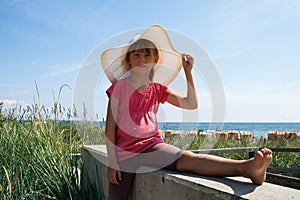 Cute girl in hat on the beach