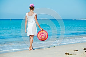 Girl with hat on the beach