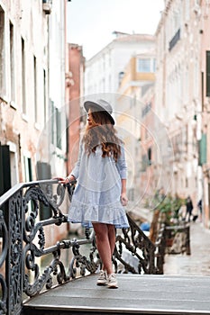 Girl in a hat and dress in Venice