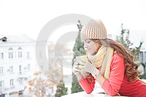 The girl in the hat froze and drinking hot tea